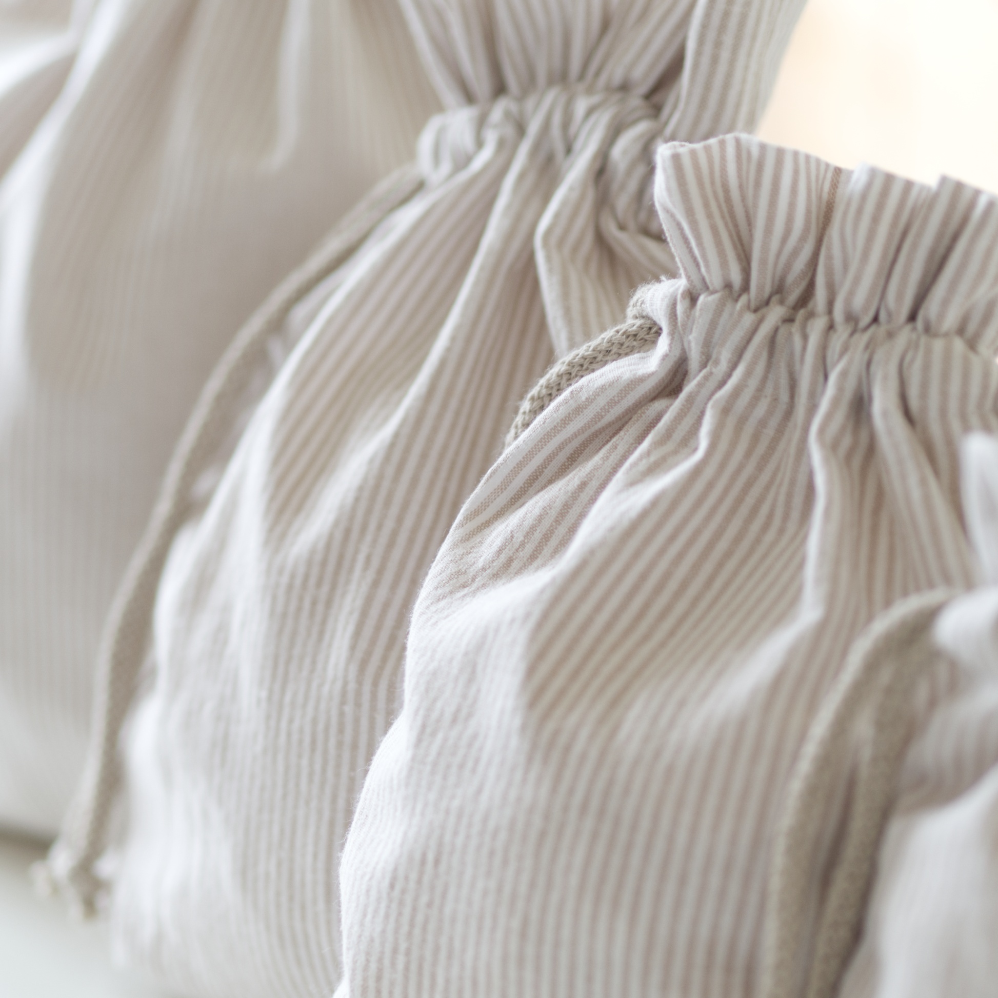 Multiple sizes of drawstring bags for a beginner friendly sewing pattern.