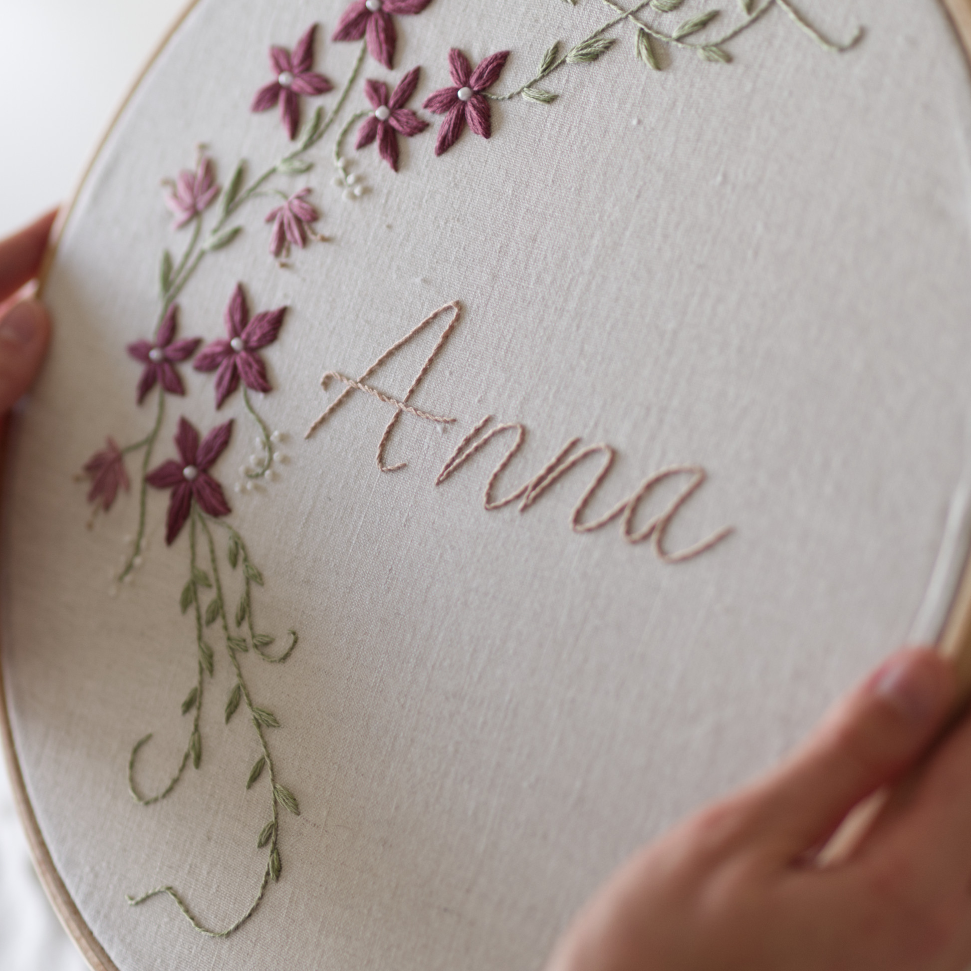 Embroidery hoop with floral design and embroidered name 'Anna'