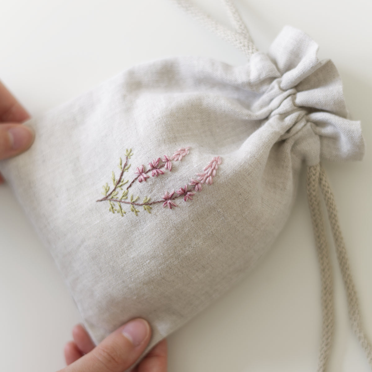 small heather-embroidered, handmade drawstring bag